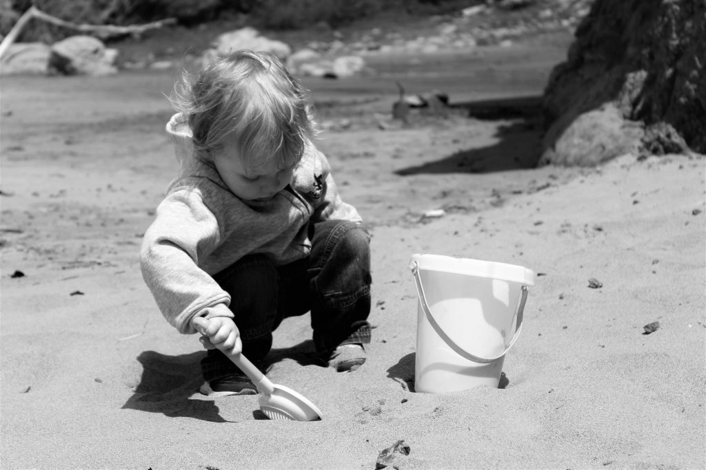 bucket filling, child at beach, bucket and spade